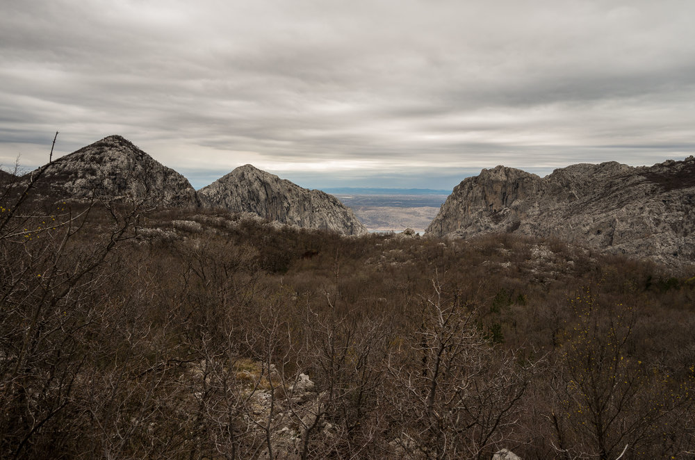 The rocky Grabove Doline plateau with the peaks of the gorge and sea beyond.
